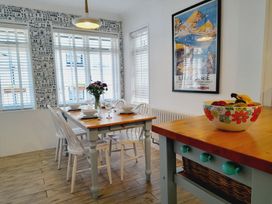 A dining room with a table and chairs at Crab Cottage in Ilfracombe