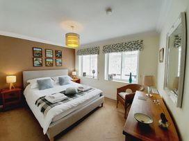 A bedroom with a bed and bedside table at Crab Cottage in Ilfracombe