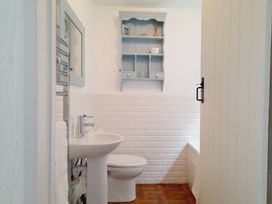 A bathroom with a sink and toilet at Crab Cottage in Ilfracombe