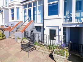 A patio area with steps and a chair at Apt 1 @ Hunter's Quay, Bridlington