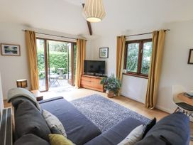 A living room with a sofa and television at Doe Foot Cottage Ingleton