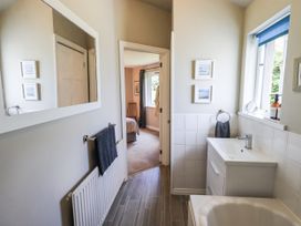 A bathroom with a sink and mirror at Doe Foot Cottage Ingleton