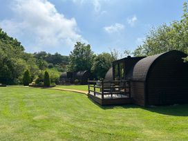A garden with cabins and a deck at Gelert Pod St Asaph