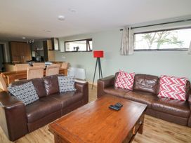 A living room with a sofa and table at The Owl's Hoot in Tacumshane, County Wexford