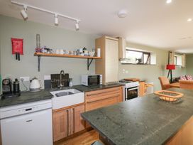 A kitchen with sink and appliances at The Owl's Hoot in Tacumshane, County Wexford