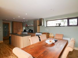 A kitchen with a dining table and chairs at The Owl's Hoot in Tacumshane, County Wexford