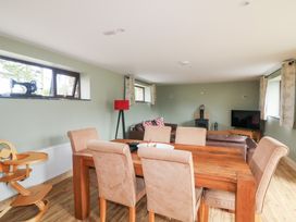 A dining room with a table and chairs at The Owl's Hoot in Tacumshane, County Wexford