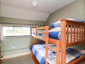 A bedroom with a bunk bed and window at The Owl's Hoot in Tacumshane, County Wexford