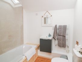 A bathroom with bathtub, sink, and toilet at The Owl's Hoot in Tacumshane, County Wexford