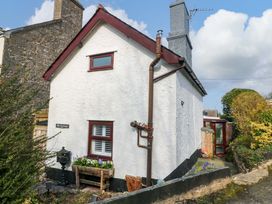 An outdoor view of a cottage with a garden and pathway at The Cottage Marian-Glas