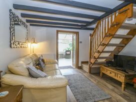 A living room with a sofa and stairs at The Cottage in Marian-Glas