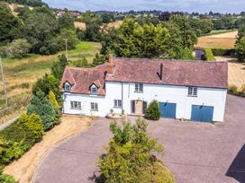 A house with a garage and driveway at Lower Tundridge Cottage Suckley near Malvern