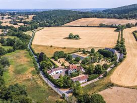 An aerial view of a property with fields and trees at Lower Tundridge Cottage Suckley near Malvern