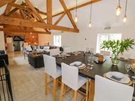 A dining room with a large table set for a meal at Lower Tundridge Cottage Suckley near Malvern