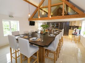 A kitchen with a dining area and modern appliances at Lower Tundridge Cottage Suckley near Malvern
