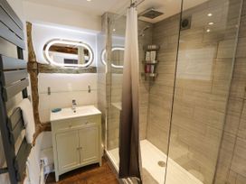 A bathroom with a shower and vanity at Lower Tundridge Cottage Suckley near Malvern