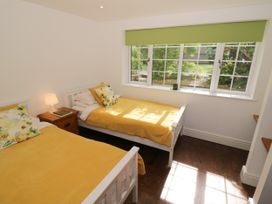 A bedroom with two beds and a window at Lower Tundridge Cottage Suckley near Malvern