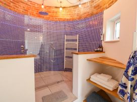 A bathroom with a shower and towel rack at Lower Tundridge Cottage Suckley near Malvern