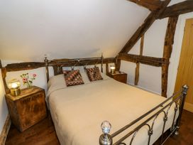 A bedroom with a bed and bedside table at Lower Tundridge Cottage Suckley near Malvern