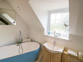 A bathroom featuring a bathtub and sink at Lower Tundridge Cottage Suckley near Malvern