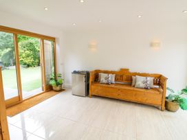 A snug with a wooden bench and small refrigerator at Lower Tundridge Cottage Suckley near Malvern