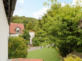 A view of houses and trees in the garden at Lower Tundridge Cottage Suckley near Malvern