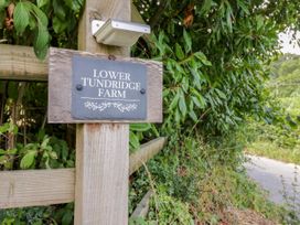 A sign for Lower Tundridge Farm on a wooden post outdoors at Lower Tundridge Cottage Suckley near Malvern