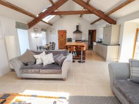 A living room with a kitchen area at Wern Olau Cottage Groeslon near Caernarfon