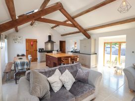 A kitchen with a dining area and seating at Wern Olau Cottage Groeslon near Caernarfon