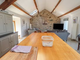 A kitchen with a table and chairs at Wern Olau Cottage Groeslon near Caernarfon