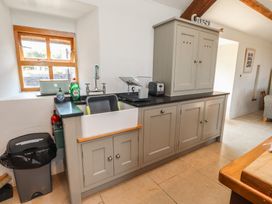 A kitchen with a sink and cupboards at Wern Olau Cottage Groeslon near Caernarfon