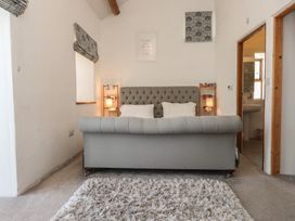A living room with a couch and window at Wern Olau Cottage in Groeslon near Caernarfon