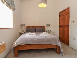 A bedroom with a bed and nightstand at Wern Olau Cottage Groeslon near Caernarfon