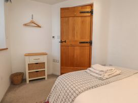 A bedroom with a bed and drawer unit at Wern Olau Cottage in Groeslon near Caernarfon