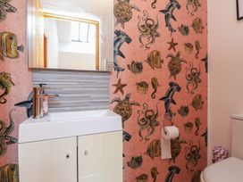 A bathroom with a sink and toilet at Wern Olau Cottage Groeslon near Caernarfon