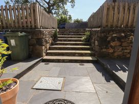 An outdoor area with steps and a stone fence at Wern Olau Cottage Groeslon near Caernarfon