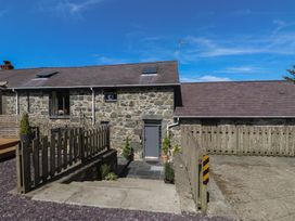 An outdoor area with a stone building and steps at Wern Olau Cottage, Groeslon near Caernarfon