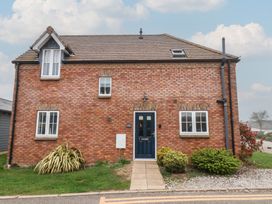 A brick house with a blue front door at Coastal Cottage The Bay near Filey