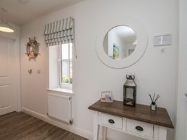A hallway with a table and mirror at Coastal Cottage The Bay near Filey