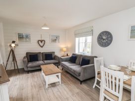 A living room with sofas and a dining table at Coastal Cottage The Bay near Filey