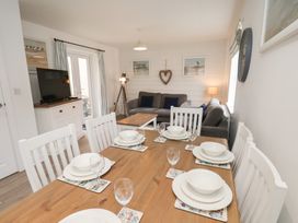 A dining room with a table set for dinner at Coastal Cottage The Bay near Filey