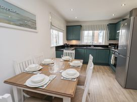 A kitchen with a dining table set for a meal at Coastal Cottage The Bay near Filey
