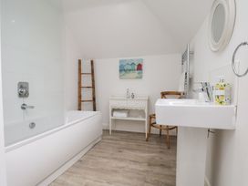 A bathroom with a bathtub and sink at Coastal Cottage The Bay near Filey