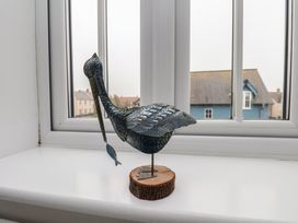 A bird statue on a window sill at Coastal Cottage The Bay near Filey