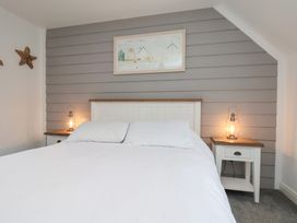 A bedroom with a bed and nightstands at Coastal Cottage The Bay near Filey