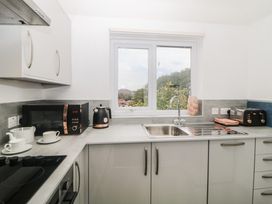 A kitchen with a microwave kettle sink toaster and tea set at Monkbarns in Brixham