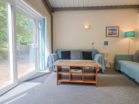 A living room with a coffee table and sofas at Brookfield Lodge in Drimpton