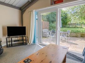 A living room with a television and coffee table at Brookfield Lodge in Drimpton