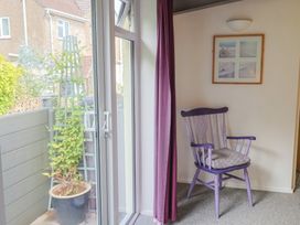 A garden room with a purple chair and a plant pot at Brookfield Lodge in Drimpton