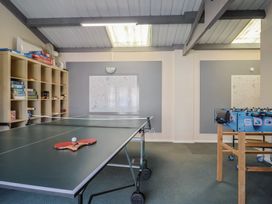 A recreation room with a ping pong table and foosball table at Brookfield Lodge in Drimpton